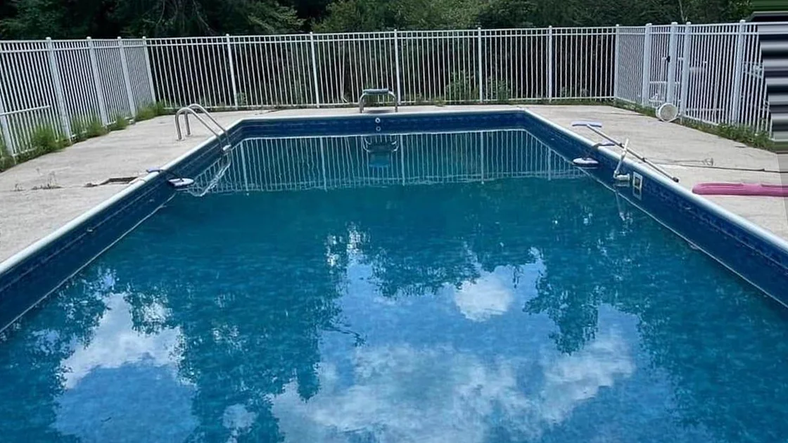 The same pool after the clean, clear blue water reflecting the sky