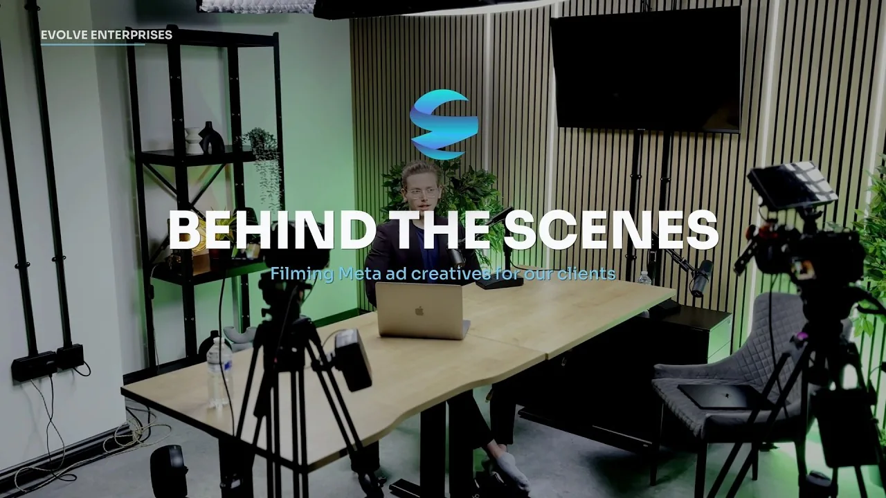 Behind the scenes of a client filming day: presenter at a desk surrounded by cameras and studio lights
